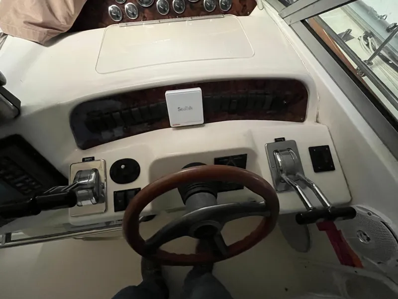 Slide: The Image of 1996 Sea Ray 330 Sundancer helm with steering wheel and control panel. - 15