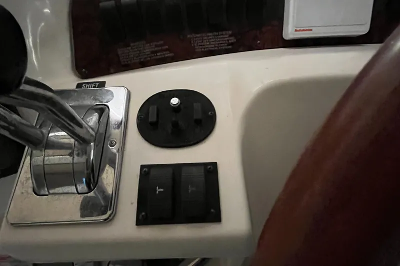 Slide: The Image of Control panel of a 1996 Sea Ray 330 Sundancer boat with throttle and switches. - 19