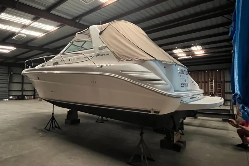 Slide: The Image of 1996 Sea Ray 330 Sundancer boat stored indoors on stands. - 2