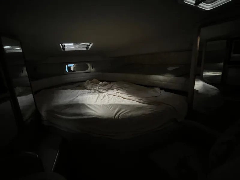 Slide: The Image of Cozy cabin interior of 1996 Sea Ray 330 Sundancer yacht with bed and ambient lighting. - 21