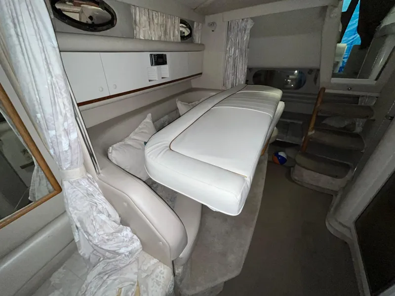 Slide: The Image of Interior of a 1996 Sea Ray 330 Sundancer boat, featuring seating and cushions. - 26