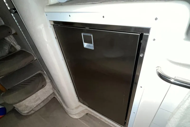 Slide: The Image of 1996 Sea Ray 330 Sundancer interior with stainless steel refrigerator. - 27