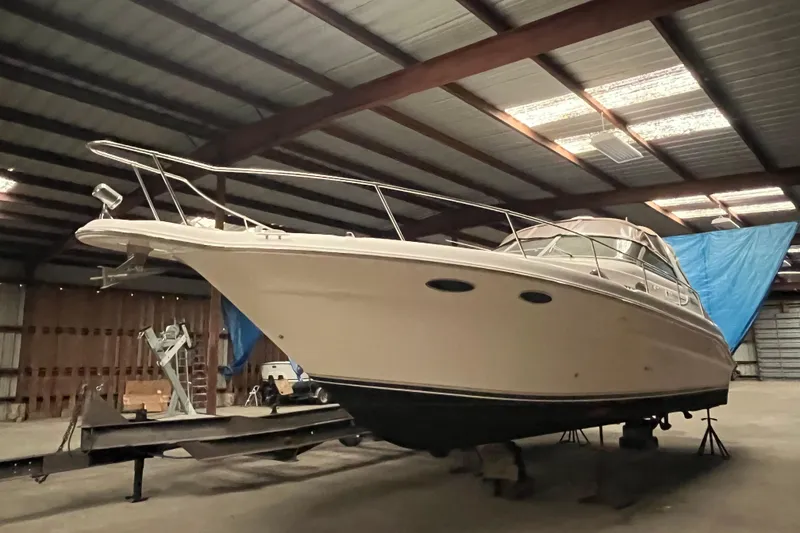 Slide: The Image of 1996 Sea Ray 330 Sundancer yacht in indoor storage, side view. - 3