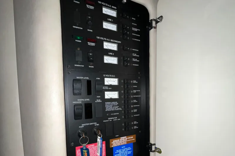 Slide: The Image of Electrical panel inside 1996 Sea Ray 330 Sundancer boat, featuring various switches and controls. - 30