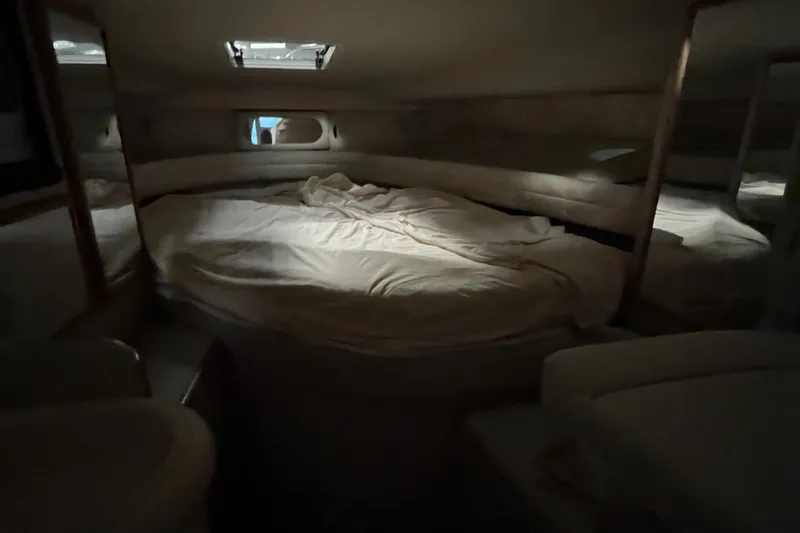 Slide: The Image of Interior cabin of 1996 Sea Ray 330 Sundancer with cozy bed and soft lighting. - 32