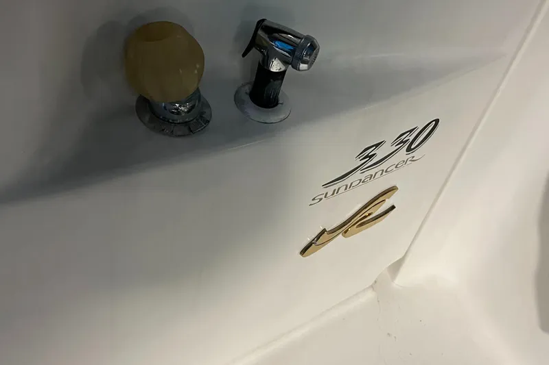 Slide: The Image of 1996 Sea Ray 330 Sundancer boat detail with logo and hardware. - 34