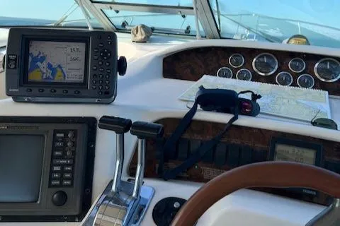 Slide: The Image of 1996 Sea Ray 330 Sundancer dashboard with navigation equipment and controls. - 37