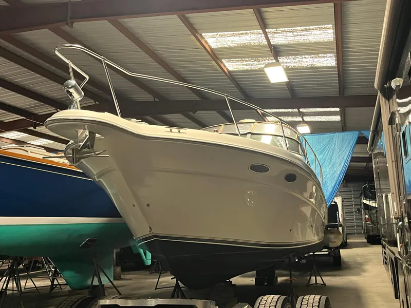Slide: The Image of 1996 Sea Ray 330 Sundancer boat in storage, viewed from the front in a covered facility. - 5