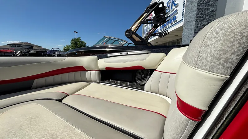 Slide: The Image of 2015 Malibu Wakesetter 22 MXZ interior with beige and red seating, showcasing luxury and comfort. - 6