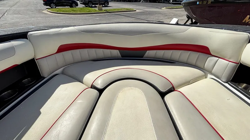 Slide: The Image of 2015 Malibu Wakesetter 22 MXZ boat interior with beige and red seating. - 8