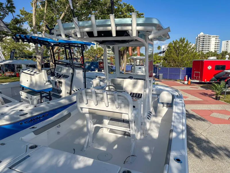Slide: The Image of 2025 Caymas 24 HB boat displayed outdoors, featuring a sleek design and modern amenities. - 14