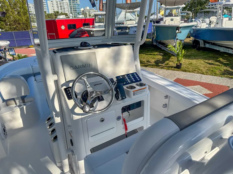 Slide: The Image of 2025 Caymas 24 HB boat cockpit with Garmin navigation system and steering wheel. - 15