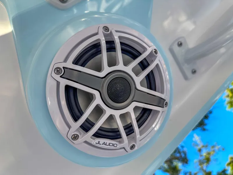 Slide: The Image of JL Audio speaker on 2025 Caymas 24 HB boat, clear sky reflection. - 16