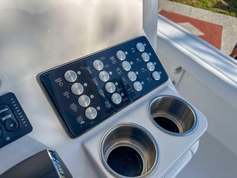 Slide: The Image of Control panel and cup holders on 2025 Caymas 24 HB boat. - 21