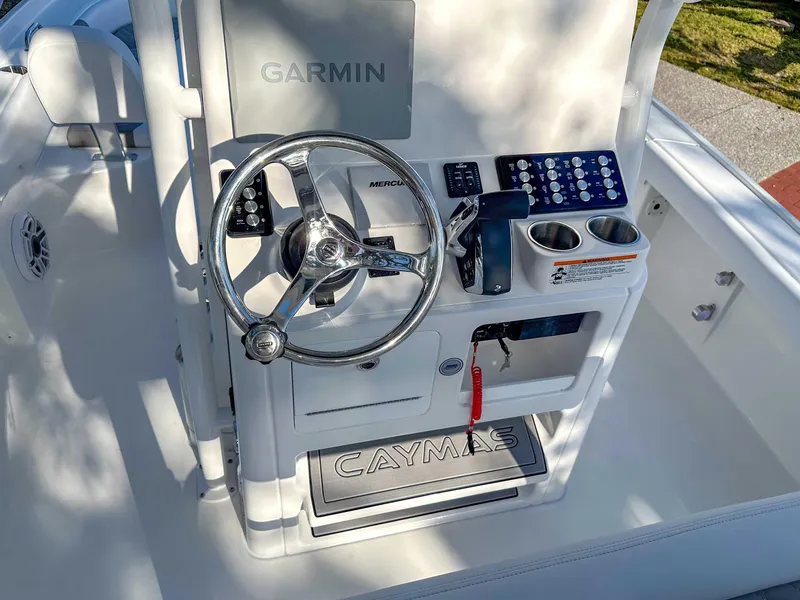 Slide: The Image of 2025 Caymas 24 HB boat console with Garmin system and steering wheel. - 24