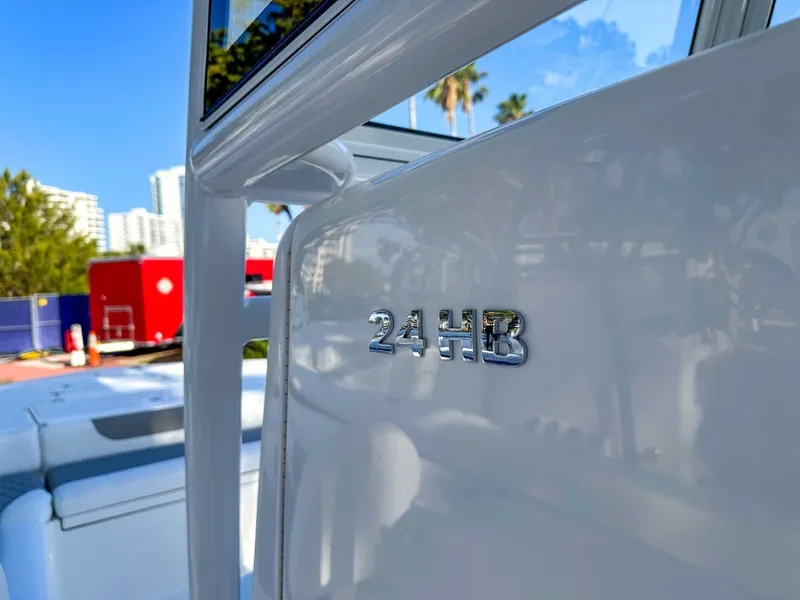 Slide: The Image of 2025 Caymas 24 HB boat detail with logo, outdoor setting. - 27
