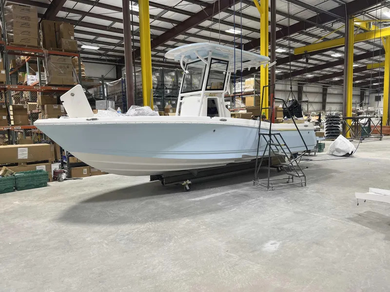 Slide: The Image of 2025 Caymas 24 HB boat in a warehouse, showcasing sleek design and modern features. - 29