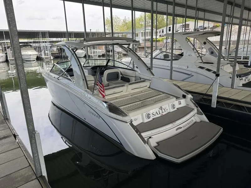 Slide: The Image of 2018 Cobalt R30 boat docked in a marina, featuring sleek design and American flag. - 10