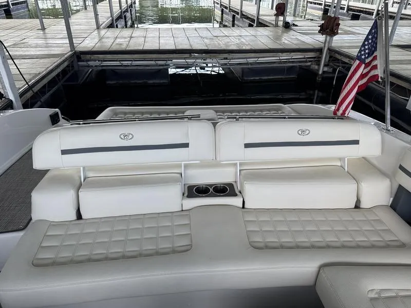 Slide: The Image of 2018 Cobalt R30 boat with white seating and American flag in docked position. - 11