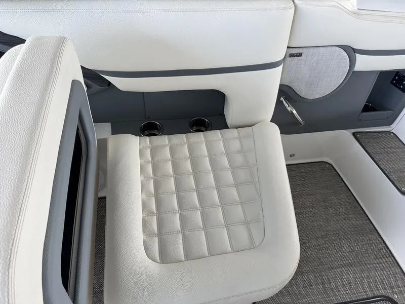 Slide: The Image of 2018 Cobalt R30 boat interior with white quilted seating and cup holders. - 12