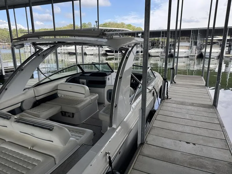 Slide: The Image of 2018 Cobalt R30 boat docked in a marina with covered slips. - 2
