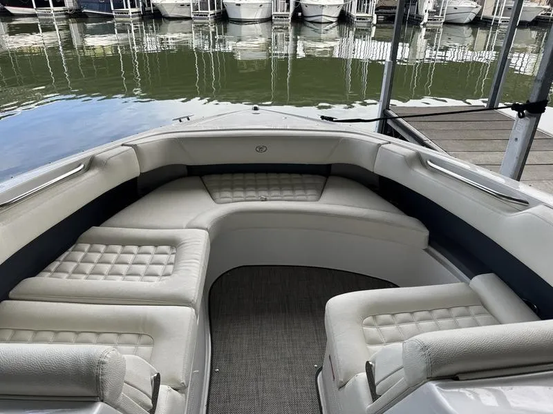 Slide: The Image of 2018 Cobalt R30 boat interior with cushioned seating, docked at marina. - 6