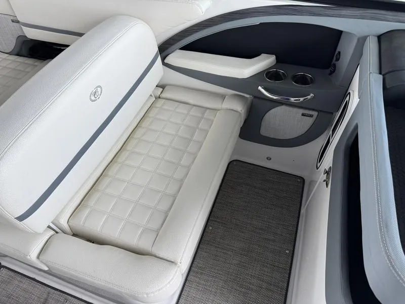 Slide: The Image of 2018 Cobalt R30 boat interior with white cushioned seating and cup holders. - 7