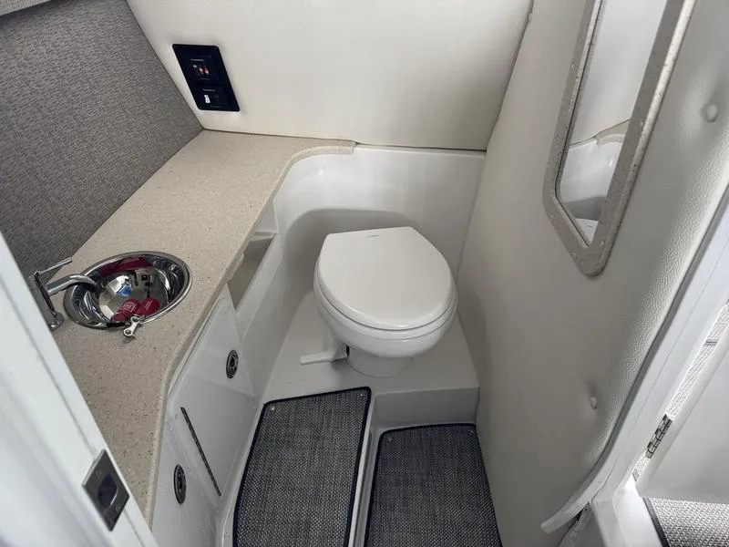 Slide: The Image of 2018 Cobalt R30 boat bathroom with toilet, sink, and mirror. - 9