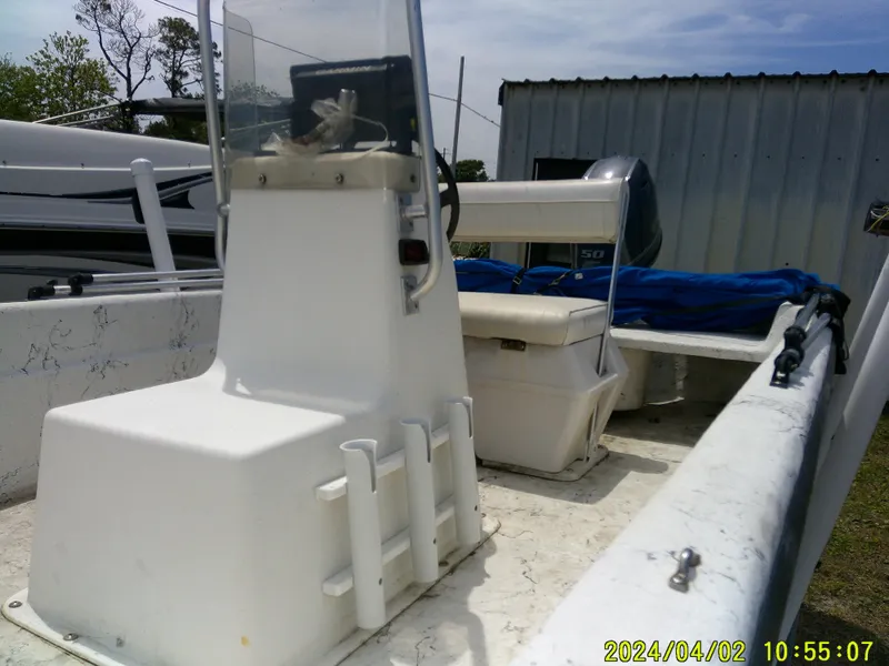 Slide: The Image of 2000 Carolina Skiff 1765 DLX boat interior with console and seating. - 13
