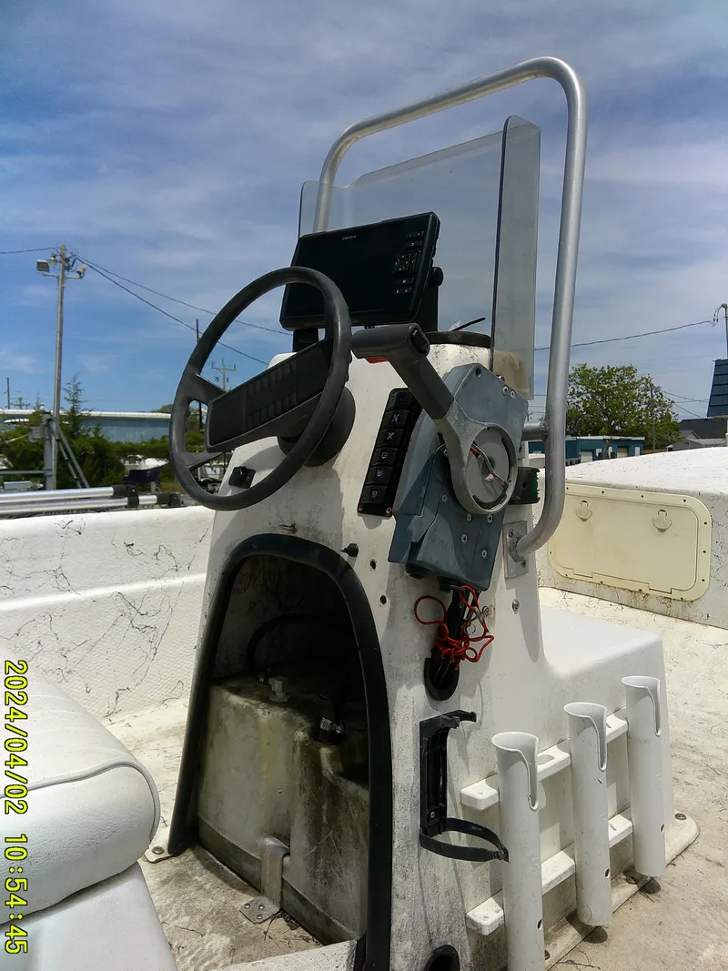 Slide: The Image of 2000 Carolina Skiff 1765 DLX boat console with steering wheel and controls. - 3