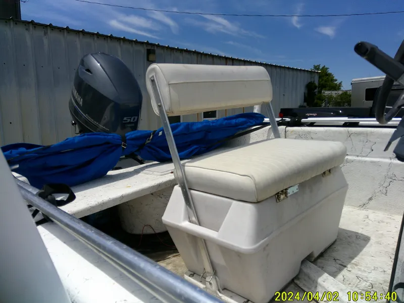 Slide: The Image of 2000 Carolina Skiff 1765 DLX boat interior with seating and Yamaha outboard motor. - 7