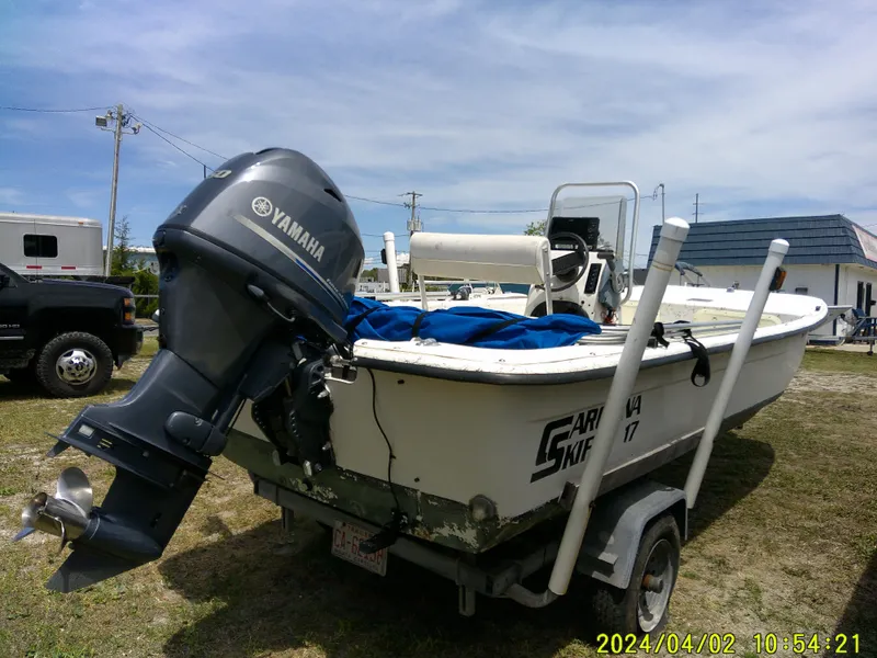 Slide: The Image of 2000 Carolina Skiff 1765 DLX boat with Yamaha outboard motor on trailer. - 8