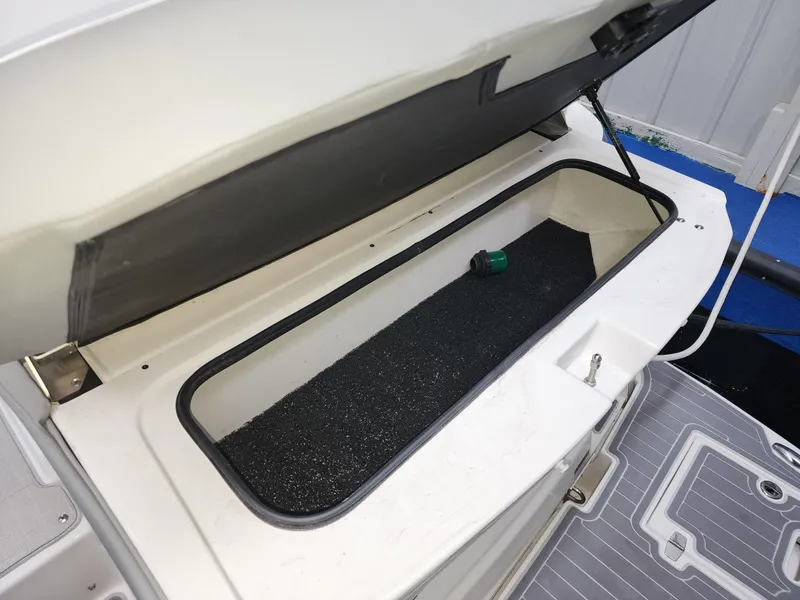 Slide: The Image of Open storage compartment on 2023 Regal 28 Express boat, showcasing interior space. - 13