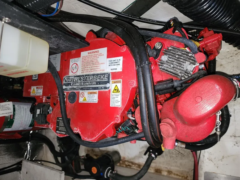 Slide: The Image of Engine compartment of 2023 Regal 28 Express with Westerbeke generator. - 14