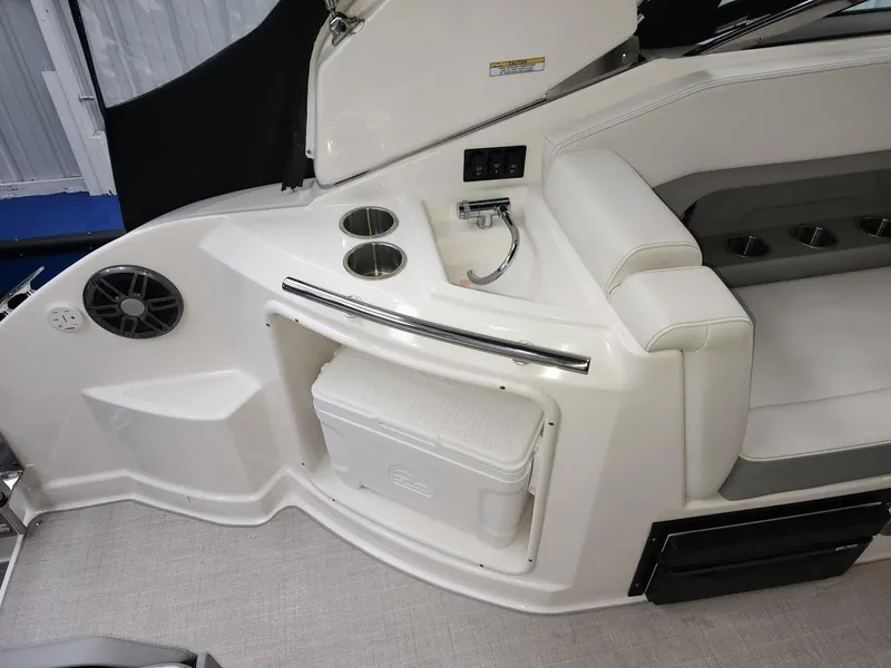 Slide: The Image of 2023 Regal 28 Express boat interior with seating, cup holders, and a built-in cooler. - 3