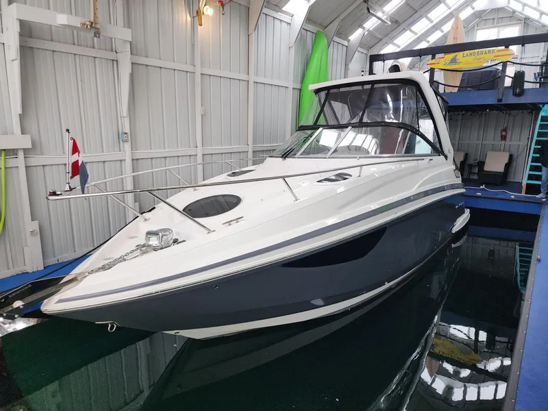 Slide: The Image of 2023 Regal 28 Express boat docked indoors, featuring sleek design and modern amenities. - 4