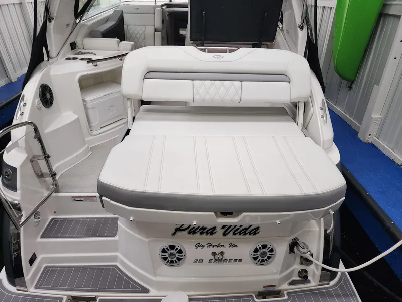 Slide: The Image of 2023 Regal 28 Express boat interior with white seating and modern amenities. - 5