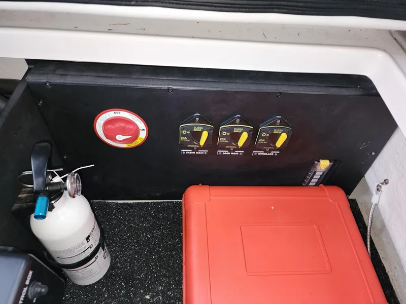 Slide: The Image of Control panel and fire extinguisher in 2023 Regal 28 Express boat interior. - 8