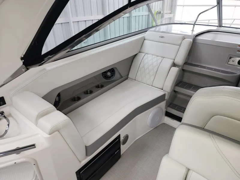 Slide: The Image of 2023 Regal 28 Express boat interior with white seating and cup holders. - 9