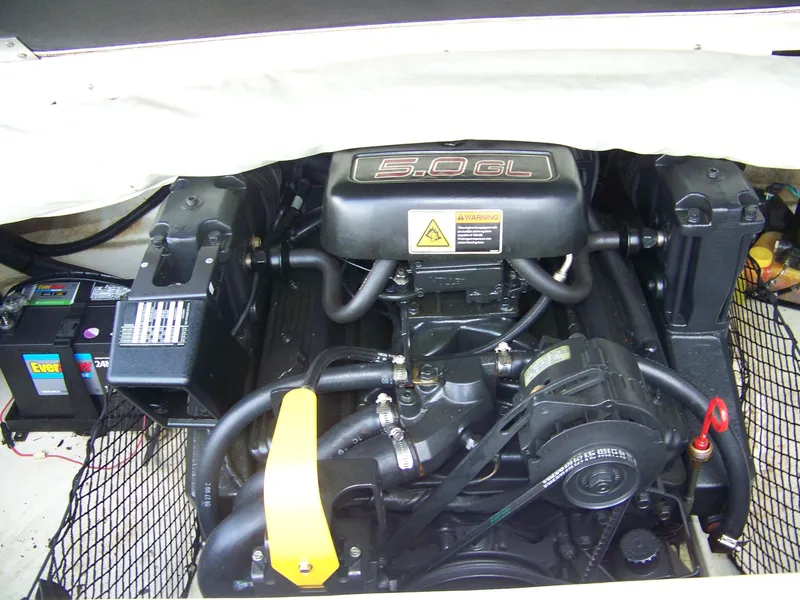 Slide: The Image of Engine compartment of a 2000 Glastron SX195 boat, featuring a 5.0 GL engine. - 11