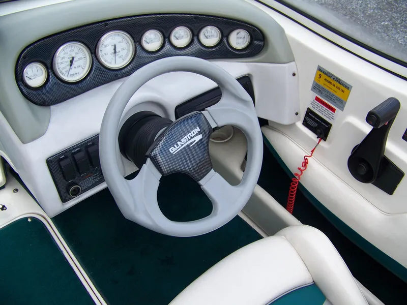 Slide: The Image of Steering wheel and dashboard of a 2000 Glastron SX195 boat. - 5