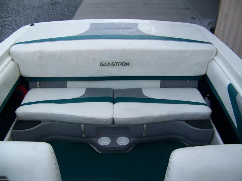 Slide: The Image of 2000 Glastron SX195 boat interior with white and teal seating. - 9