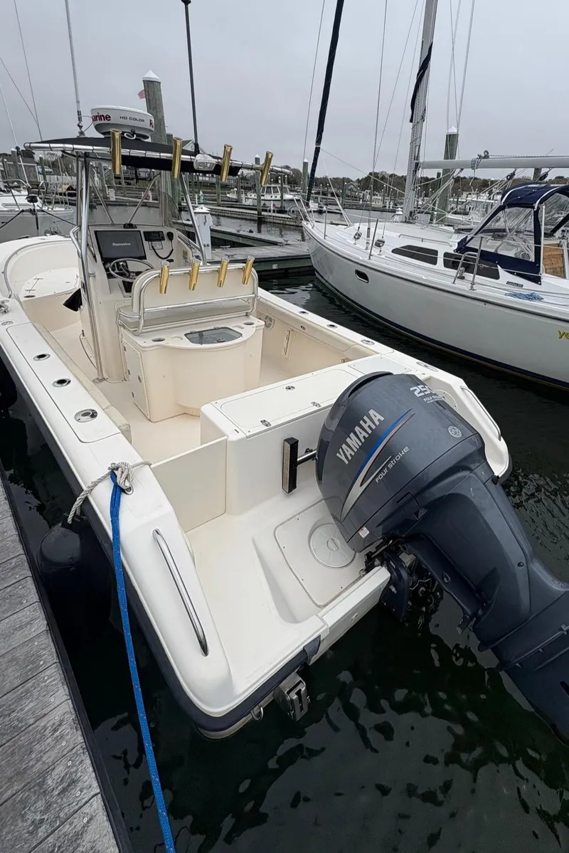 Slide: The Image of 2008 Pursuit 2570 CC boat docked, featuring Yamaha outboard motor. - 14