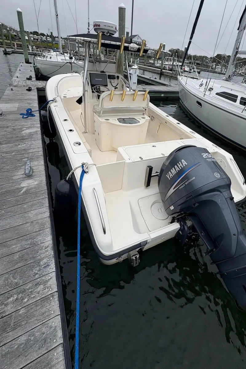 Slide: The Image of 2008 Pursuit 2570 CC boat docked with Yamaha outboard motor. - 15