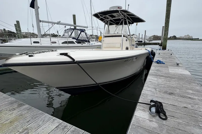 Slide: The Image of 2008 Pursuit 2570 CC boat docked at marina, side view. - 4