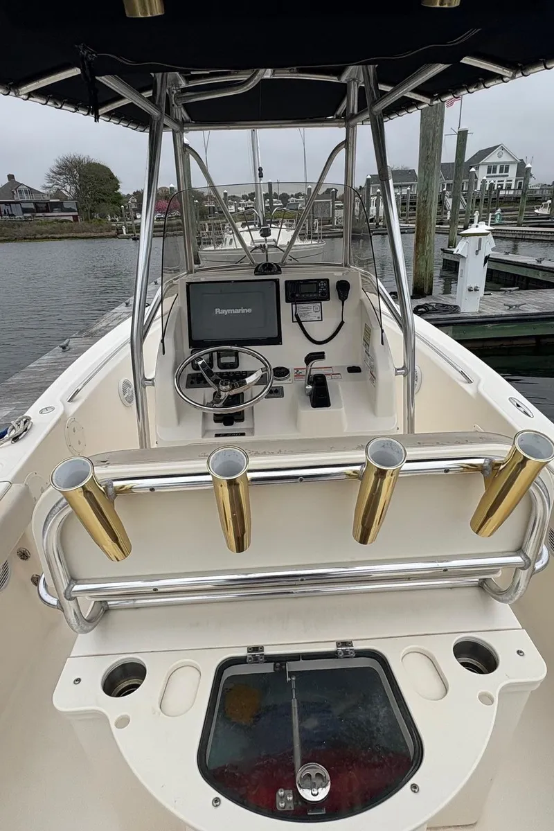 Slide: The Image of 2008 Pursuit 2570 CC boat with center console and fishing rod holders. - 5