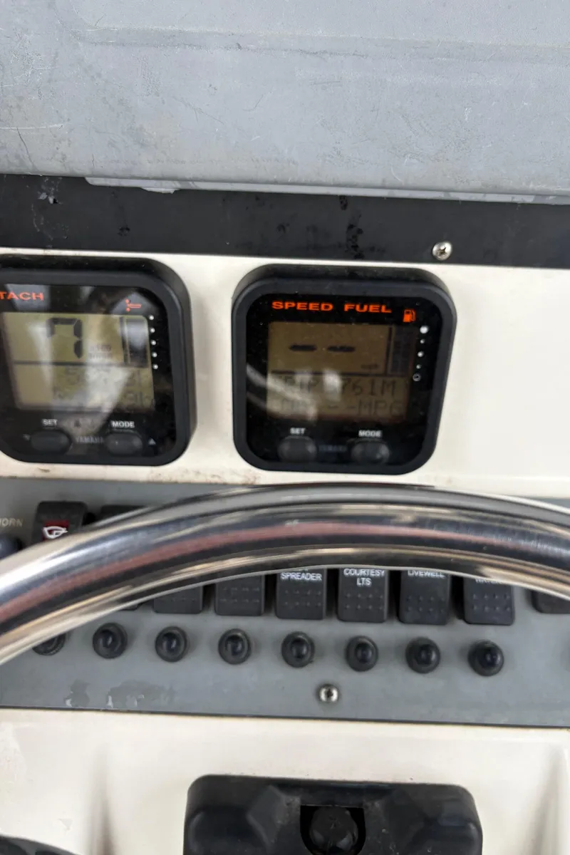 Slide: The Image of Dashboard of a 2008 Pursuit 2570 CC boat with speed and fuel gauges. - 9