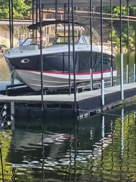 Slide: The Image of 2010 Cobalt 302 boat docked on a calm lake under a covered slip. - 1