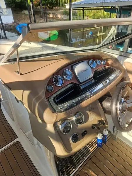Slide: The Image of 2010 Cobalt 302 boat dashboard with steering wheel and gauges. - 11