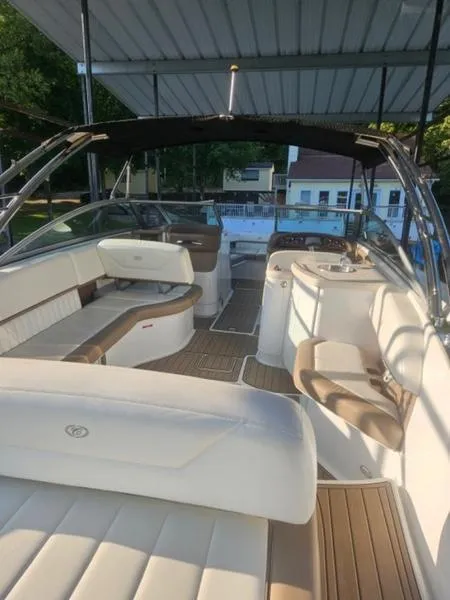 Slide: The Image of 2010 Cobalt 302 boat interior with seating and helm under canopy. - 13